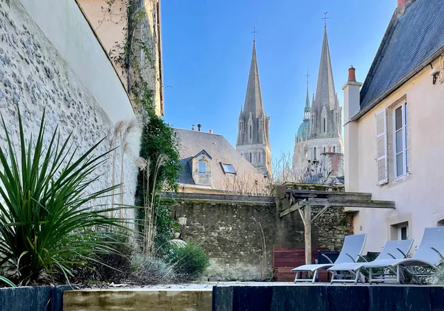 Maison à Bayeux avec son jardin et les flèches de la cathédrale en arrière-plan
